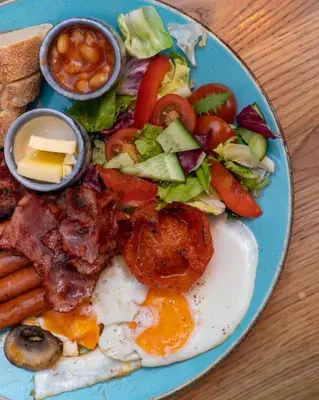 a blue plate of food with an egg and a salad at Discover Krakow Apartments - 3 Rakowicka St - Amazing Loft near Main Station - Netflix in Kraków