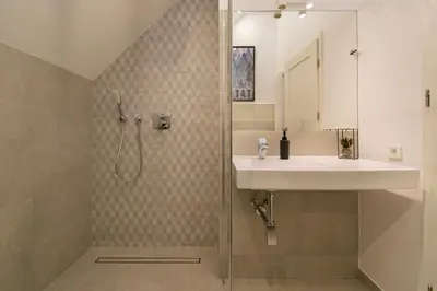 a bathroom with a sink and a shower with a sink at Duplex apartment in the center of Krakow in Kraków