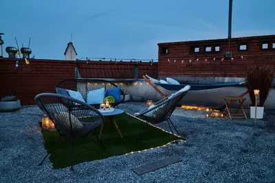a patio with two chairs and a table and a couch at Duplex apartment in the center of Krakow in Kraków