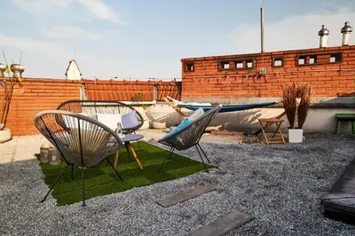 a patio with two chairs and a table and a boat at Duplex apartment in the center of Krakow in Kraków