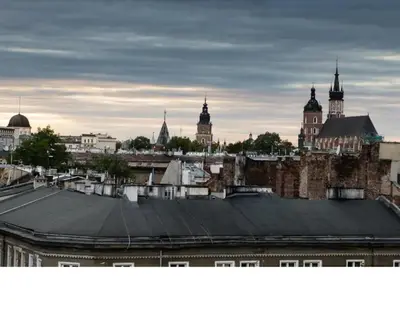 a view of the roofs of a city with buildings at Duplex apartment in the center of Krakow in Kraków