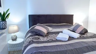 a bed with two pillows on it in a room at APARTAMENT LIPSKA 4 in Kraków