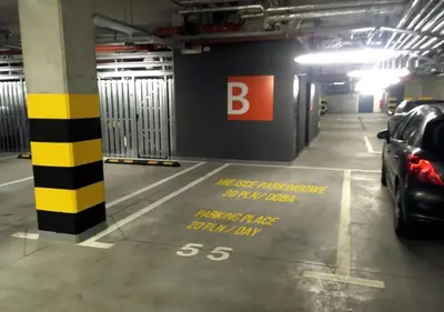 a parking garage with a car parked in it at APARTAMENT LIPSKA 4 in Kraków