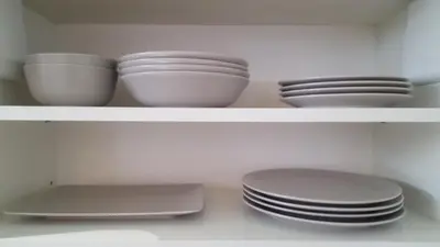 a white shelf with bowls and plates on it at Julia Apartments Rakowicka - Old Town in Kraków