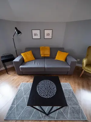 a living room with a couch and a table at Old Town Apartment Morsztynowska in Kraków