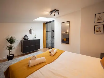 a bedroom with a large bed with towels on it at Old Town Apartment Morsztynowska in Kraków