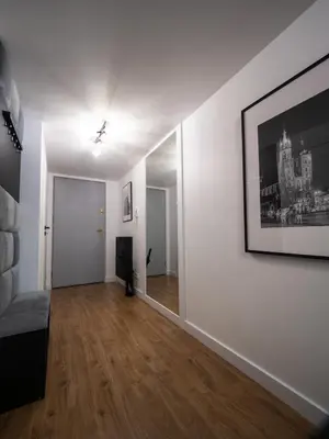 an empty room with white walls and wood floors at Old Town Apartment Morsztynowska in Kraków