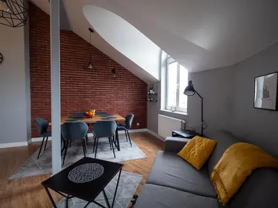 a living room with a couch and a table at Old Town Apartment Morsztynowska in Kraków