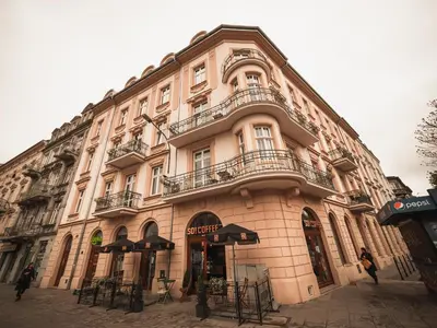 a large tan building with balconies on a street at Old Town Apartment Morsztynowska in Kraków