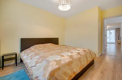 a bedroom with a large bed in a room at Apartment Kordiana in Kraków