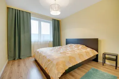a bedroom with a bed and a large window at Apartment Kordiana in Kraków