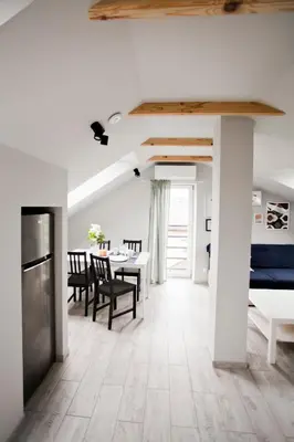a kitchen and dining room with a table and chairs at Spokojna Apartamenty in Trzebinia