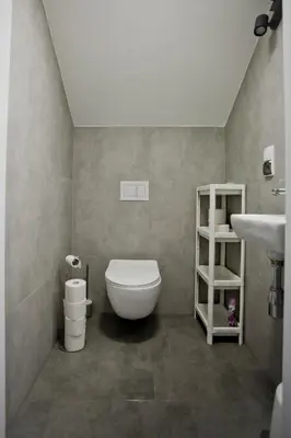 a bathroom with a toilet and a sink at Spokojna Apartamenty in Trzebinia