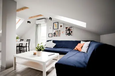 a living room with a blue couch and a table at Spokojna Apartamenty in Trzebinia