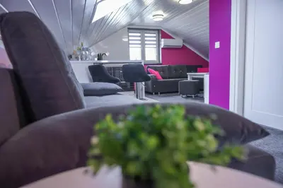 a room with couches and a table with a plant at Rajska Oaza in Przybradz