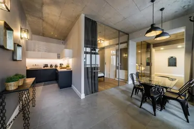 a dining room and kitchen with a table and chairs at Groble Residence WAWELOFTS in Kraków