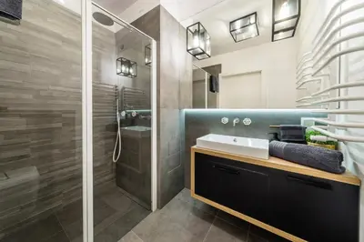 a bathroom with a sink and a shower at Groble Residence WAWELOFTS in Kraków