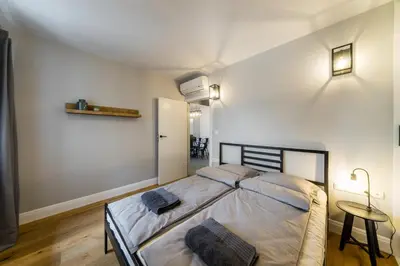 a bedroom with a bed with two pillows on it at Groble Residence WAWELOFTS in Kraków