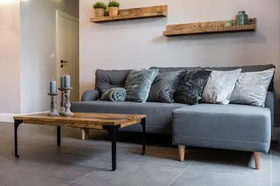 a living room with a couch and a table at Groble Residence WAWELOFTS in Kraków