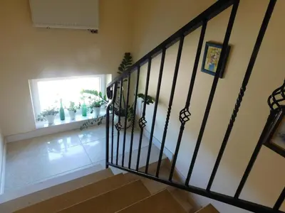 a staircase in a house with a window and plants at Pokoje gościnne Barka in Wadowice