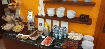 a counter with a bunch of dishes and plates on it at Domus Mater Hotel in Kraków