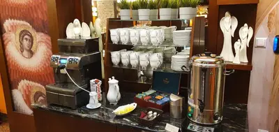a coffee shop with a counter with a coffee machine at Domus Mater Hotel in Kraków