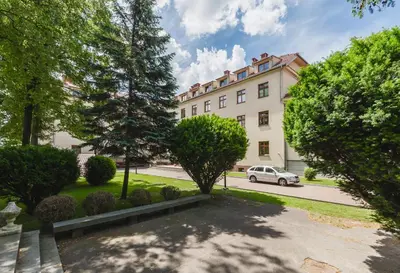 a building with a car parked in front of it at Domus Mater Hotel in Kraków