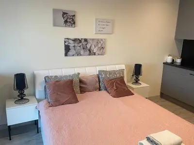 a bedroom with a bed with pink sheets and pillows at Rajska 3 ap 206 by Atrium Apartments in Kraków