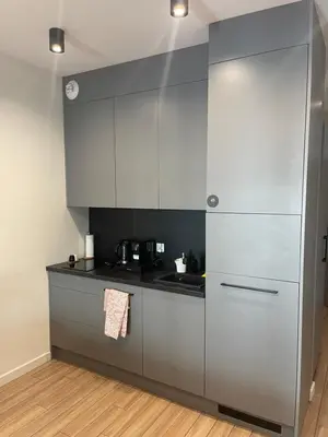 a kitchen with gray cabinets and a counter top at Rajska 3 ap 206 by Atrium Apartments in Kraków