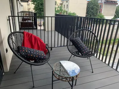 two chairs and a table on a balcony at Rajska 3 ap 206 by Atrium Apartments in Kraków