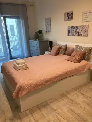 a bedroom with a large bed with orange sheets at Rajska 3 ap 206 by Atrium Apartments in Kraków