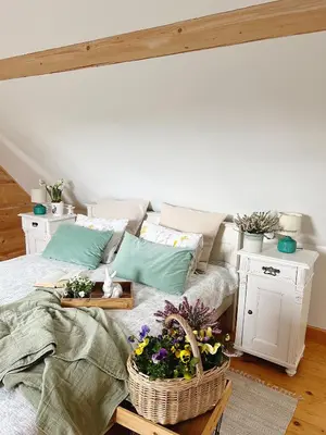 a bedroom with a bed with flowers on it at Góralskie domy w Łostówce in Łostówka