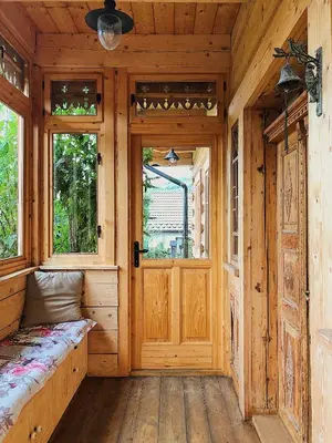 a wooden room with a wooden door and windows at Góralskie domy w Łostówce in Łostówka