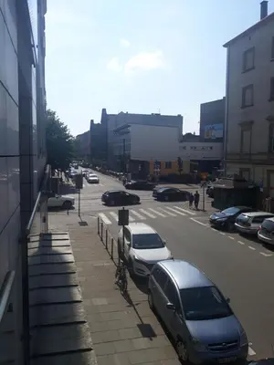 a street with cars parked in a parking lot at Negroni Apartments in Kraków