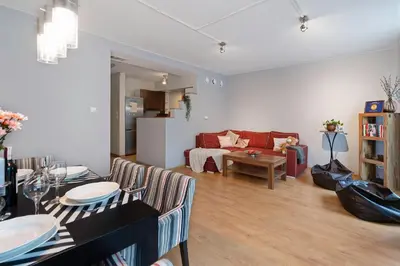 a living room with a couch and a table at Negroni Apartments in Kraków
