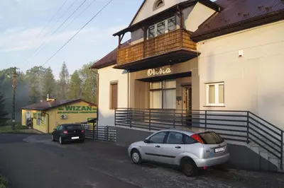 a white car parked in front of a building at OLIVIA in Osiek