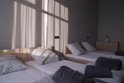 two beds in a room with white sheets and pillows at OLIVIA in Osiek