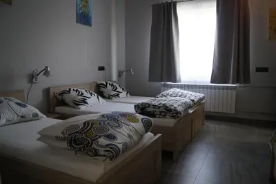 a room with three beds and a window at OLIVIA in Osiek