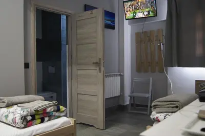 a bedroom with a door with a tv above it at OLIVIA in Osiek