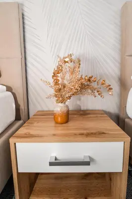 a wooden table with a vase on top of it at Apartamenty Majka in Zator