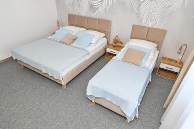 two twin beds in a room withermottermottermott at Apartamenty Majka in Zator
