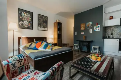 a living room with a bed and a couch at Singer Retro Studio in Kazimierz in Kraków
