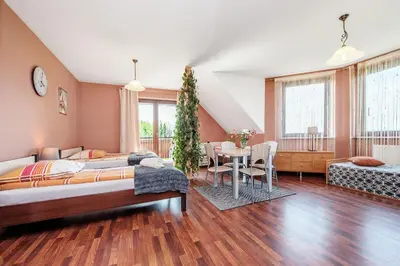 a bedroom with two beds and a table and chairs at RYSIÓWKA pokoje gościnne in Modlniczka