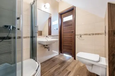 a bathroom with a sink and a toilet and a shower at RYSIÓWKA pokoje gościnne in Modlniczka