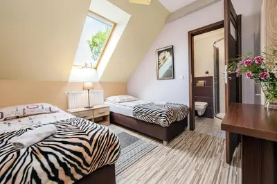 a hotel room with two beds and a desk at RYSIÓWKA pokoje gościnne in Modlniczka