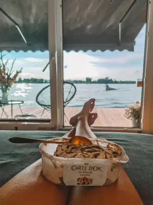 a bowl of food sitting on a table next to the water at Costa del Kryspi Całoroczne Domy na Wodzie in Cholerzyn