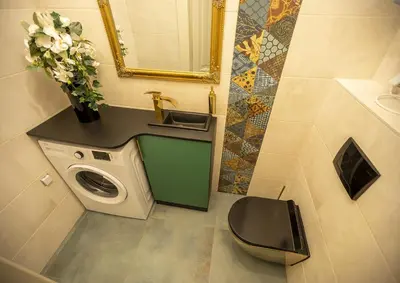 a bathroom with a sink and a washing machine at Mikołajska 5 Apartments in Kraków