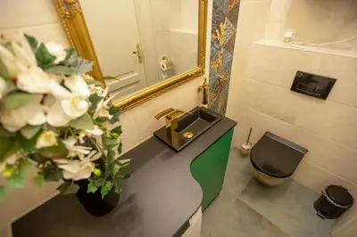 a bathroom with a sink and a toilet and a mirror at Mikołajska 5 Apartments in Kraków