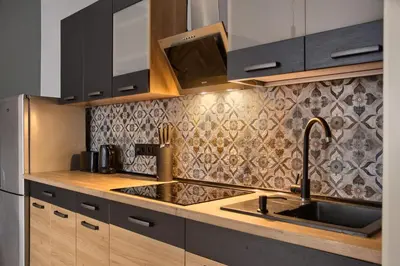 a kitchen with wooden cabinets and a sink at Mikołajska 5 Apartments in Kraków