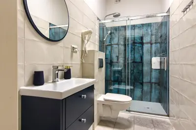 a bathroom with a toilet and a sink and a shower at Mikołajska 5 Apartments in Kraków